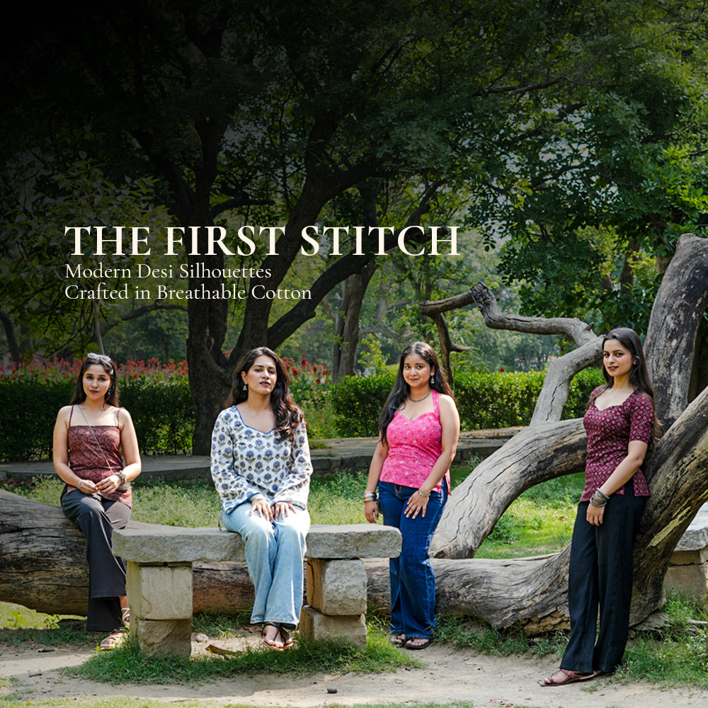 Four women posing outdoors with a tree and bench in the background, featuring 'The First Stitch' branding.