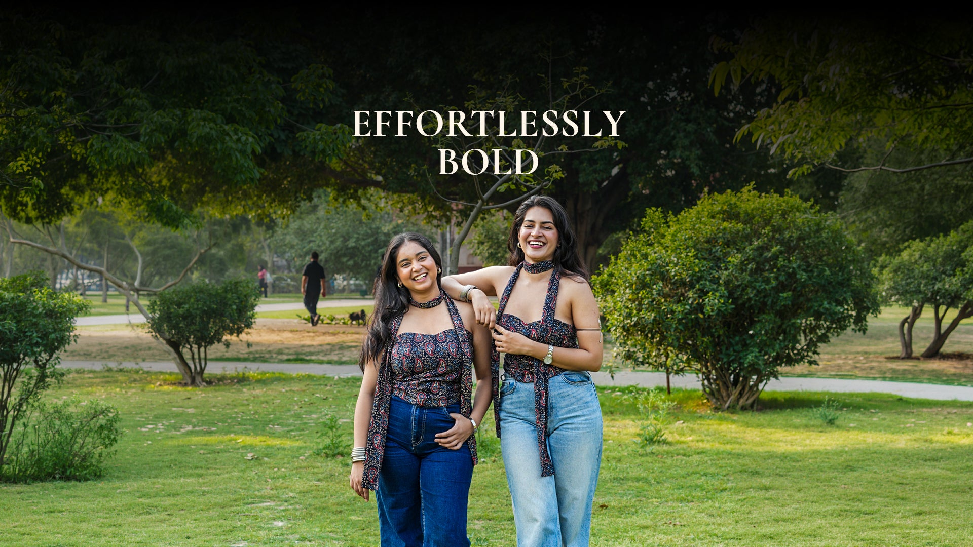 Two women standing in a park with 'Effortlessly Bold' text overlay